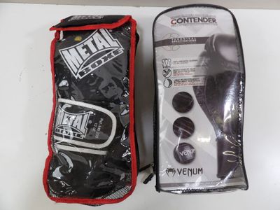 metal muay mitt and bag in packaging on a white surface