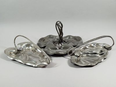 four pieces of silverware are sitting on a white surface