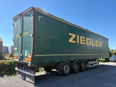 the truck is green with yellow lettering on the side of it