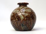 a brown and white vase sitting on a white surface
