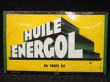 panneau jaune et vert portant l'inscription « huile energoll »