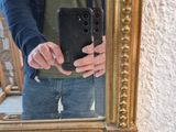 a man that is taking a picture of himself in a mirror