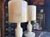 two lamps that are sitting on a glass table