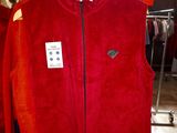 a red jacket hanging on a clothes rack in a store