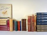 a lot of books that are stacked on top of each other