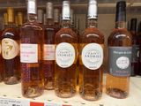 several bottles of wine are on a shelf in a store