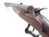 an old gun with a wooden handle on a white background