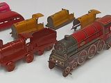 a lot of toy trains that are sitting on a table