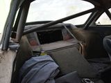 a dirty car with a seat in the back of it