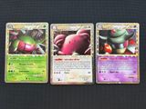 three pokemon cards are sitting on top of a table