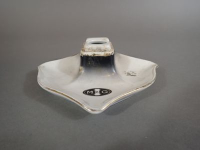 a silver plate that has a small square on it