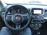 dashboard of a small car with a steering wheel and dashboard controls
