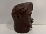 an image of a wooden mask on a white surface