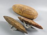 three pieces of stone and a rock on a white surface