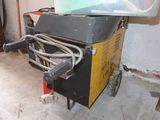 a machine that is sitting on a cart in a room