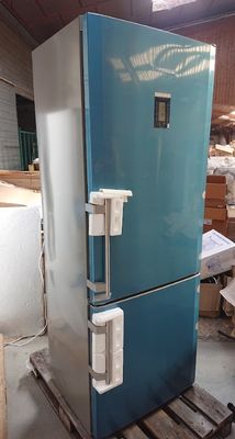 a blue refrigerator sitting in a warehouse next to a pallet