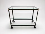 a glass and brass bar cart with wheels on a white background