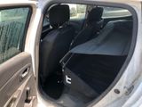 the back seat of a car with the door open and the passenger seat folded down