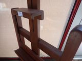 a wooden chair that is sitting in front of a glass door