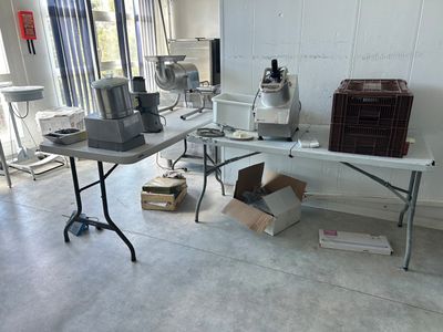 a table with a mixer and other items on it in a room