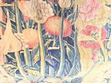 a close up of a painting of flowers on a wall
