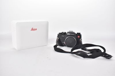 an image of a camera and a box on a white surface