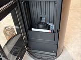 a black stove with a door open in a room