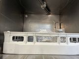 a white boat in the back of a truck