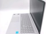 a white laptop with a blue sticker on the screen