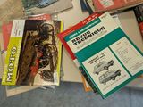 a lot of books on a table that are on top of each other