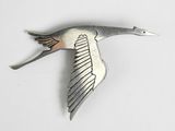 a metal bird that is flying in the air