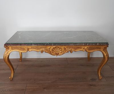 a table with a marble top on a wooden floor