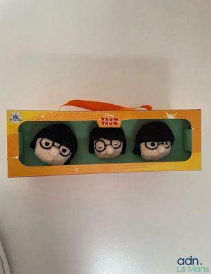 two stuffed animals in a box with a ribbon around them