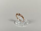 a close up of a gold ring on a clear surface