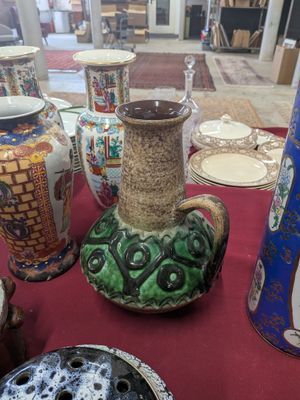 many different vases on a table with a red table cloth