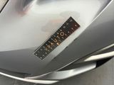 a sticker on the hood of a silver car