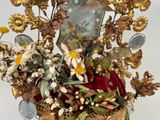 a gold vase with a bunch of flowers in it