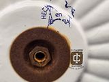 a close up view of a white plate with a brown center