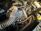 an image of a car engine with a hose attached to it