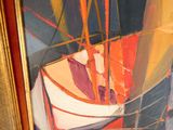 un tableau représentant un bateau, exposé dans un cadre doré