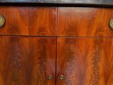 a close up of a wooden cabinet with brass knobs