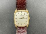 a close up of a wrist watch with a brown leather strap