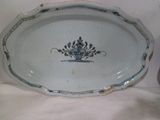 a blue and white platter with a flower design on it