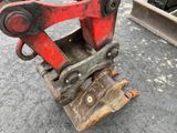 a red machine that is sitting on the ground