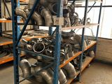 a rack with many different types of exhaust pipes on it
