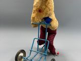 un ours en peluche assis sur un chariot