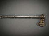 an old axe on a gray surface with a black background