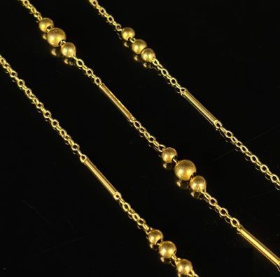 a pair of gold plated necklaces with balls and chains