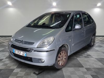 a silver car that is parked on a checkered floor