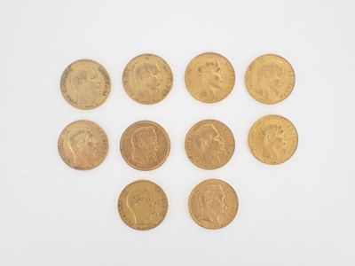 a close up of a bunch of gold coins on a white surface